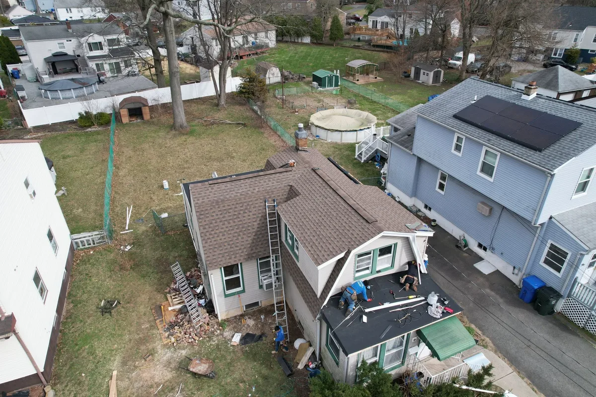 Experienced roofing specialists actively installing and sealing roofing systems in El Cajon, CA