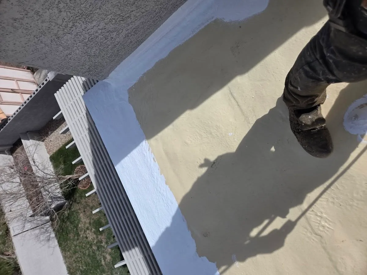 Application of reflective elastomeric waterproof roof coating on a commercial flat roof in El Cajon